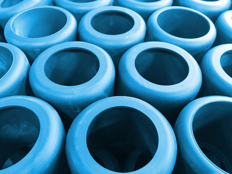 Rows of blue injection-molded plastic parts