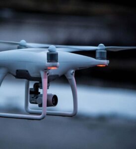 White quadcopter drone in flight